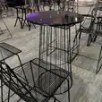 Black wire cocktail tables set up for a function