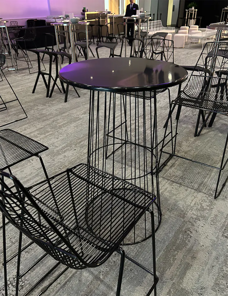 Black wire cocktail tables set up for a function