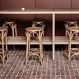 Natural blonde thonet bentwood stools arranged at a high bar for a coastal event