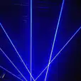 Hire a blue laser light on a stage in a dark room for an immersive experience.