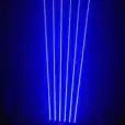 A blue light is shining on a stage in a dark room. Blue laser light illuminates the stage, creating a captivating atmosphere during events and performances.