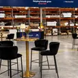 Blue marble top brass cocktail tables with black velvet bar stools at an event