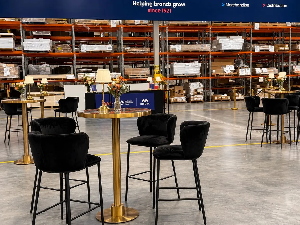 Blue marble top brass cocktail tables with black velvet bar stools at an event