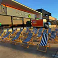 Blue and white striped deck chairs arranged outdoors for a community event beside a shopping precinct at sunset