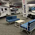 A blue wire 2 seater sofa at a campervan show
