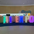 Colour changing illuminated AI EXPO letters displayed inside a corporate exhibition and conference venue