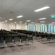 Conference chairs hired for a large indoor corporate meeting