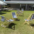 Deck chair hire: A row of blue and white deck chairs on a grassy area available for hire.