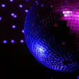 A disco ball in action with purple lights