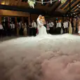 A dance floor covered in dry ice at a wedding