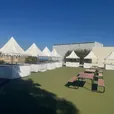 White fete stalls set up in a row for an outdoor community event