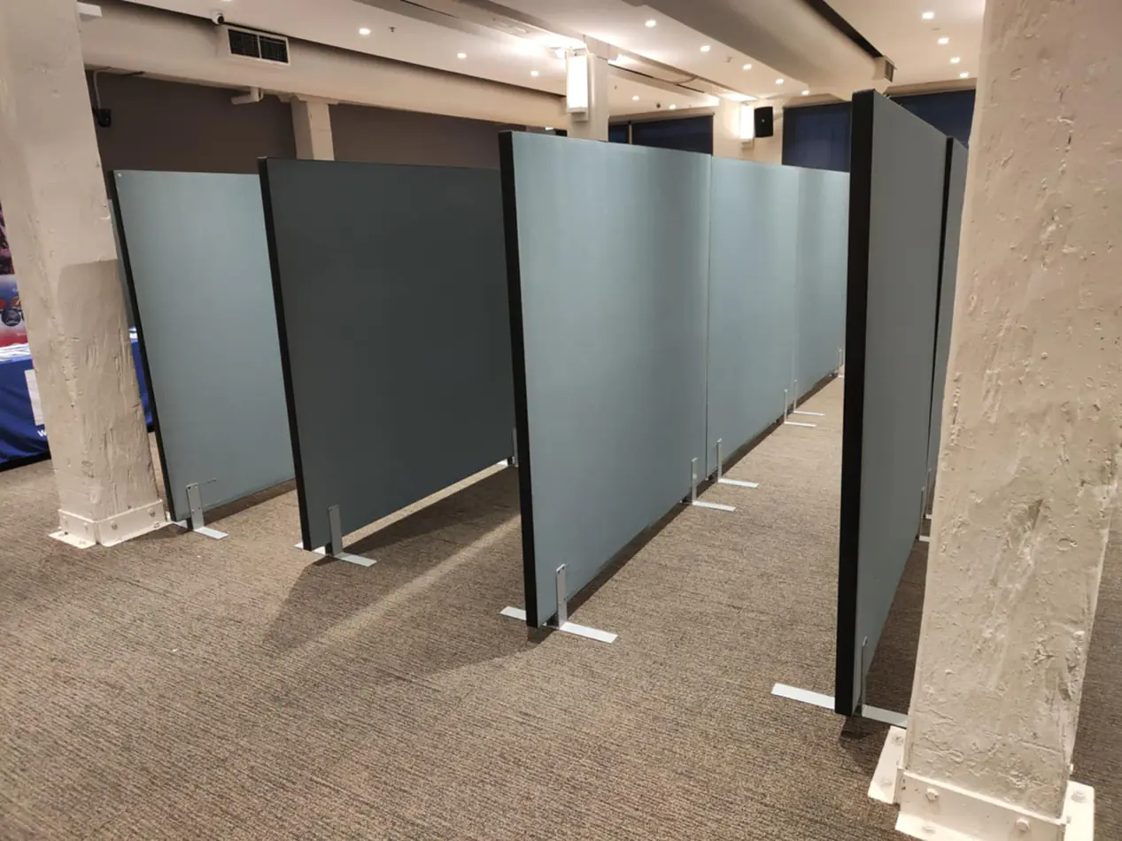 Freestanding partition panels arranged inside an indoor venue to create separated event and exhibition spaces