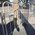 Galvanised crowd control barriers positioned along a public walkway for outdoor event crowd management and access control