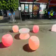 A vibrant arrangement of glow stools on a bustling street.