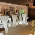 A group of white stools and a Glow Cocktail Bar table hire with lights.
