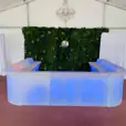 A vibrant Glow Corner Bar set up in a tent with mesmerising blue lights.