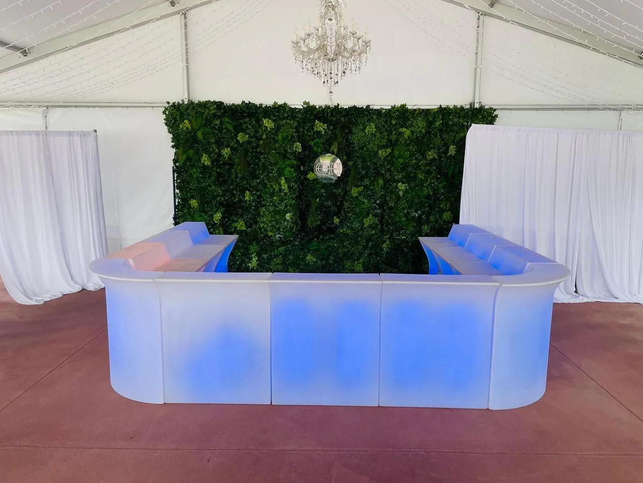 A vibrant Glow Corner Bar set up in a tent with mesmerising blue lights.