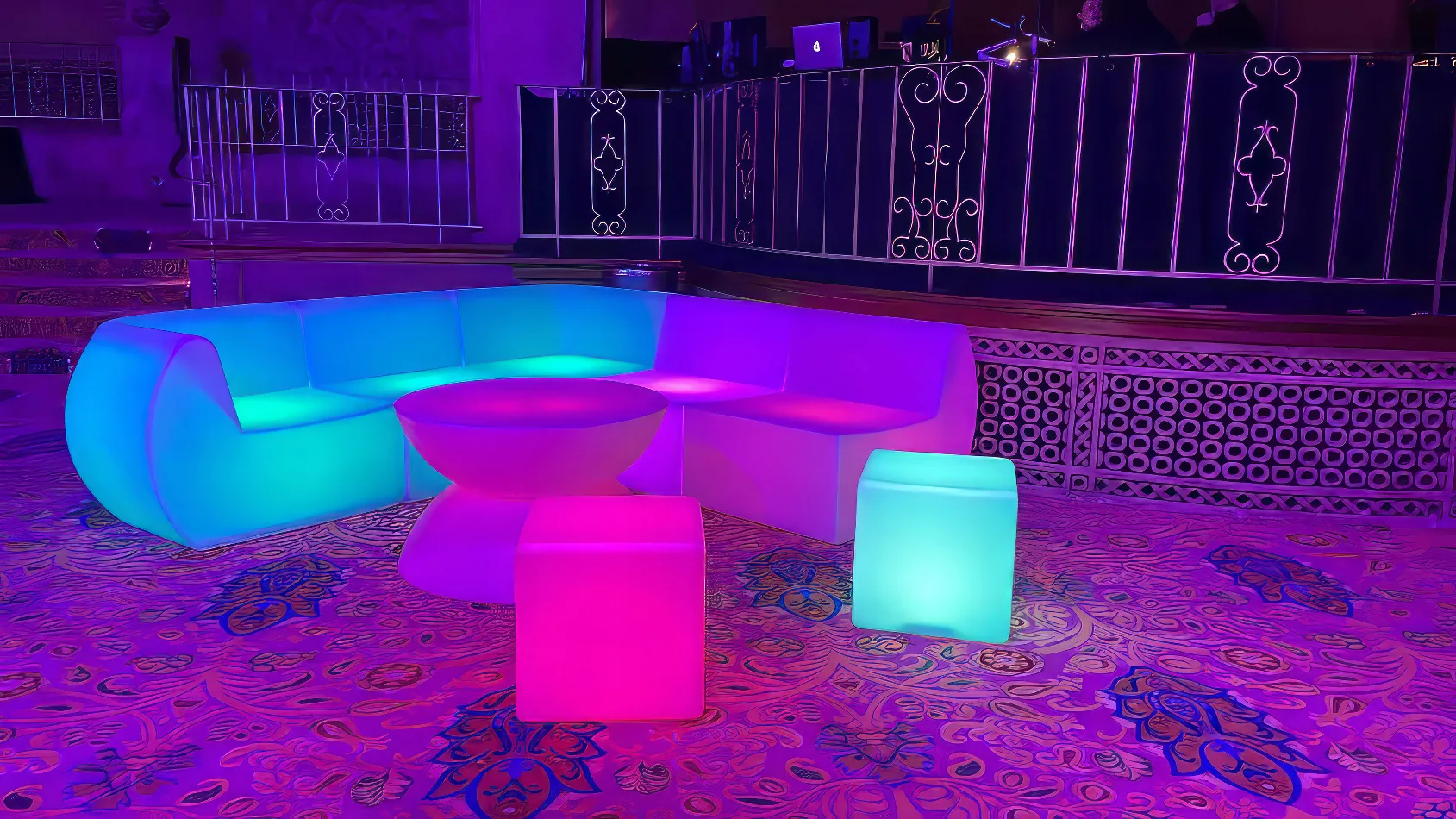 A colorful Glow Cube Hire table and chairs in a room.