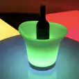 Glowing ice tub hire showcases a bottle of wine nestled in a colorful ice bucket.