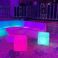 A Glow Lounge Suite Hire with colorful lights in the middle of a room.