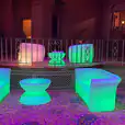 A room with colorful furniture, including a chandelier, and a glow mini coffee table hire.