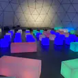 A dome filled with colorful cubes, glowing with vibrant hues.