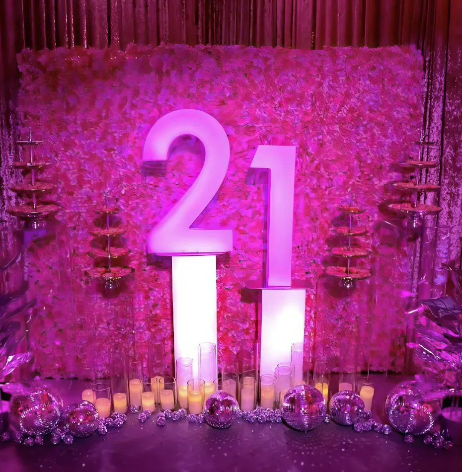 A pink backdrop with the number 21 on it for hire.