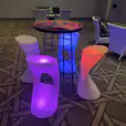 A set of colorful Glow Stool Hire in a conference room.