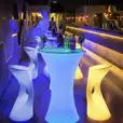 A colorful bar with glow stools and chairs.