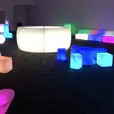 A room full of colorful LED stools and tables available for hire.
