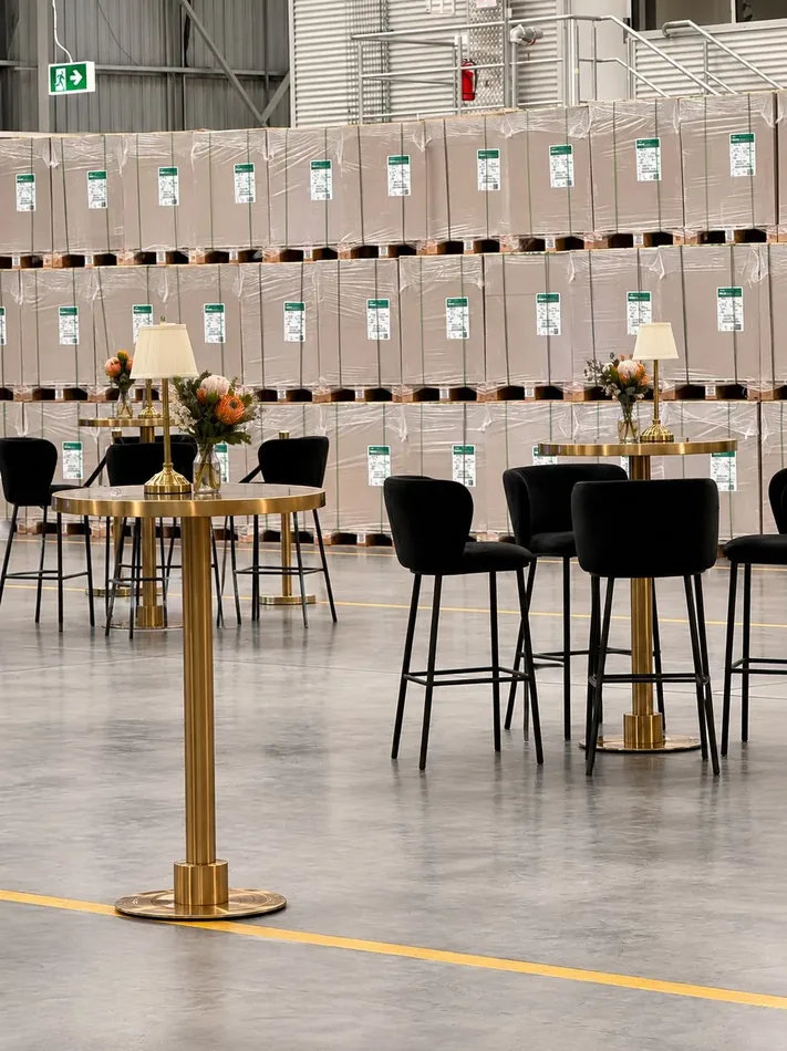 Gold Atlas bar tables with black velvet bar stools at an indoor event