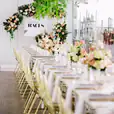 A beautifully decorated wedding reception table adorned with flowers and a sign.