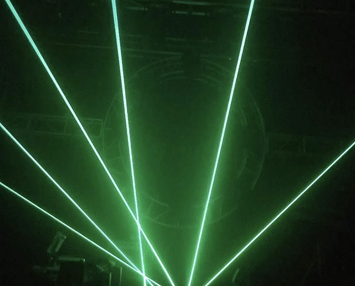 Hire a green laser light for your stage in a dark room.