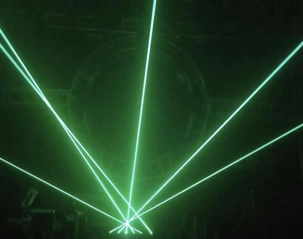 Green Laser Light Hire on a dark stage.