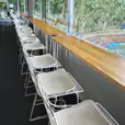 Hairpin timber top tables next door white wire stools