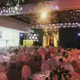 An event space with tables and chairs set up for an Intelligent Light Hire event.