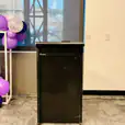 A podium with purple balloons in front of a window available for Lectern Hire.