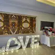 The love sign is illuminated in front of a table.