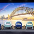 Navy blue and teal velvet Lola arm chairs arranged in an event lounge