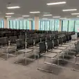 Lots of conference chairs hired for an indoor meeting