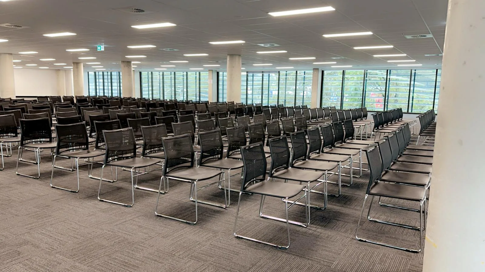 Lots of conference chairs hired for an indoor meeting