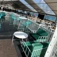 Emerald green velvet three seater lounge at a garden event