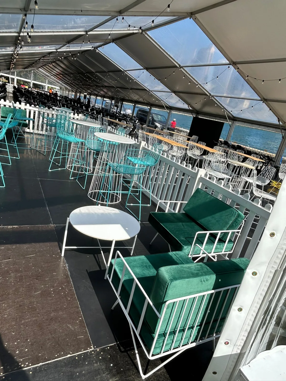 Emerald green velvet three seater lounge at a garden event