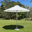 Our market umbrella providing shade in an outdoor grassy area