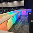 Modular LED glow bar with illuminated colour changing panels installed inside a large corporate gala venue