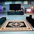 Black drape backdrop behind a catering table in a warehouse event space.