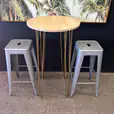 Our gold hairpin round cocktail table with Tolix stools