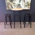 Our round cocktail table underneath a painting