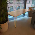 Our timber top hairpin table next to a window overlooking a building
