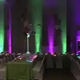 A party room with Par Can light hire, creating a vibrant atmosphere with green and purple lights.